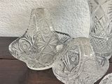 four glass vases sitting on a table next to each other