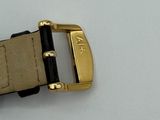 a close up of a gold buckle on a watch