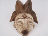 an image of a wooden mask on a white background