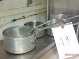 pots and pans on a counter in a kitchen with a price tag