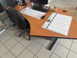 a desk with a computer monitor and a keyboard on it