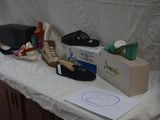 several pairs of shoes are lined up on a table next to a box