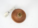 a small wooden object with a cord attached to it