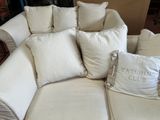 a white couch with many pillows on top of it