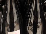 several bottles of wine are on a shelf in a store