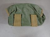 a small green bag with two tan straps on it