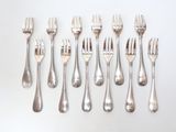 a lot of forks and spoons on the table
