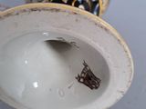a close up of a vase with a bug inside of it