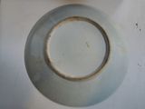 a white plate with a brown rim sitting on a table