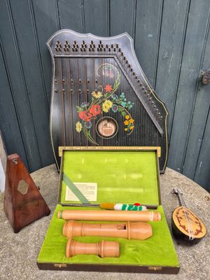 an old musical instrument sitting on a table next to other items