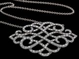 a close up of a diamond necklace on a black background