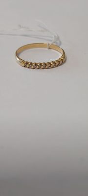 a close up of a gold ring on a white surface