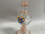 a glass vase with a horse on it on a table