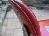 a red chair that has a sticker on the back of it