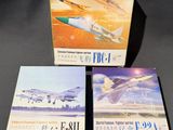 three boxed books on a table with a picture of a plane in the background