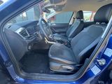 the interior of a blue car with black seats and a steering wheel