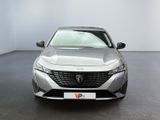 the front of a silver car parked in a showroom
