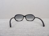 a pair of black sunglasses sitting on a white surface