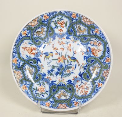un gros plan d'une assiette décorée d'oiseaux et de fleurs