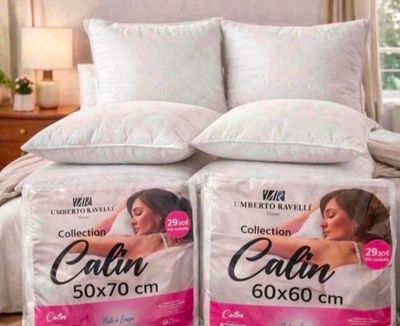 two pillows on top of a bed in a bedroom
