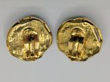 pair of gold earrings with a man and woman in the center