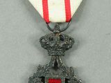 a close up of a medal with a red and white ribbon