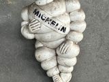 a statue of a man holding a sign that says michel