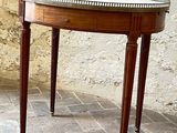 a small table with a glass top on a brick floor