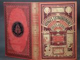 un vieux livre à la couverture rouge posé sur une table