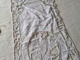 embroidered table runner with a design of flowers and leaves