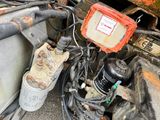 a truck that has a bunch of wires attached to the back of it