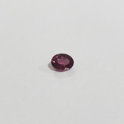 an oval cut pink tourmaline gems on a white surface