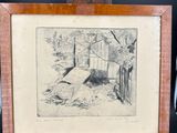 an old picture of a dog laying on the ground next to a wooden easel