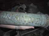 a person holding a wooden sign that says jeannie