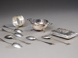 a lot of silver spoons and spoons on the table