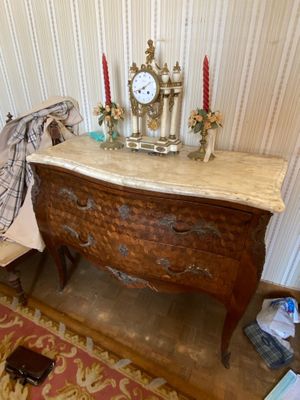 a table with a clock on top of it next to a chair