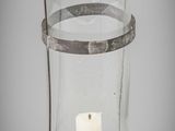 a glass candle holder with a candle inside of it