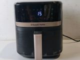 a black and silver air fryer sitting on a counter