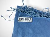 the label on a blue bag is attached to a string