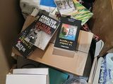 a cardboard box filled with books and other items