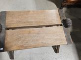 a wooden bench that is sitting in the middle of a room