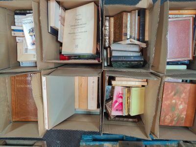 boxes of books stacked on top of each other in a room