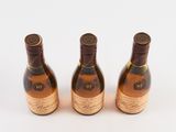 three bottles of wine sitting next to each other on a white surface