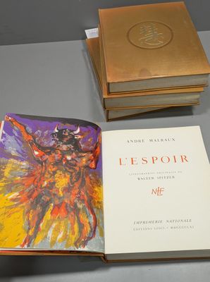 two books on a table with a box on top