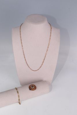 a necklace on a mannequin with a ring on it