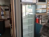 a refrigerator that is sitting in the corner of a room