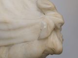 marble bust of a woman with a hat on her head