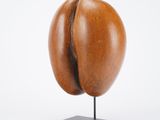 a close up of a sculpture of a coffee bean on a stand