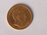 une pièce d'or sur laquelle figure l'image d'un homme