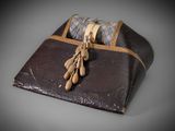 a brown leather case with some wooden spoons in it